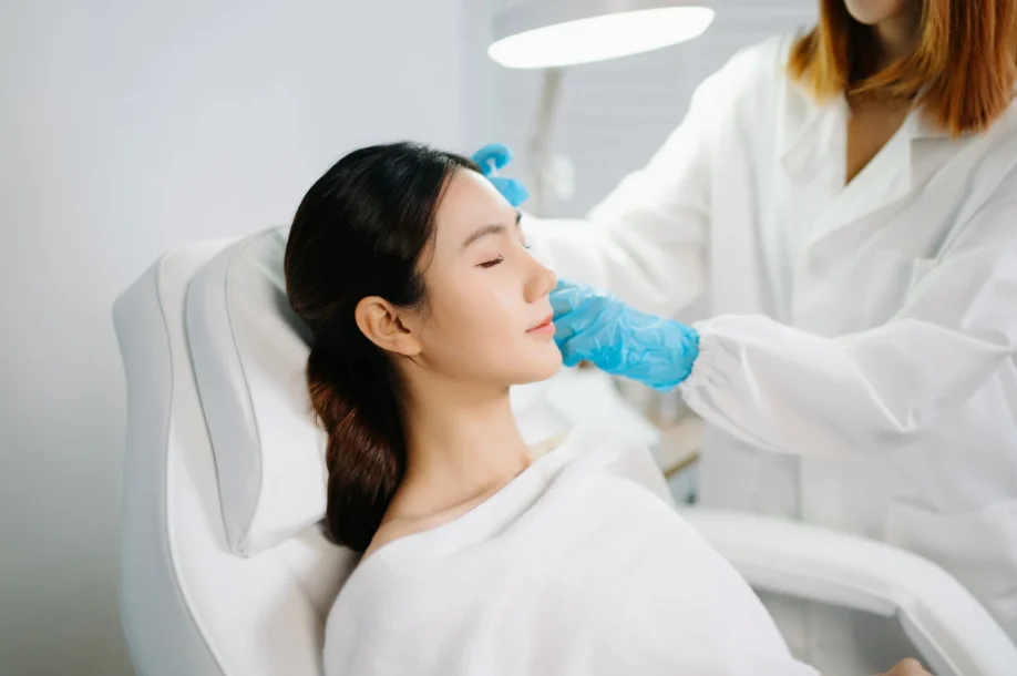 Patient undergoing a facial aesthetic assessment to determine How long does collagen stimulator last Singapore.