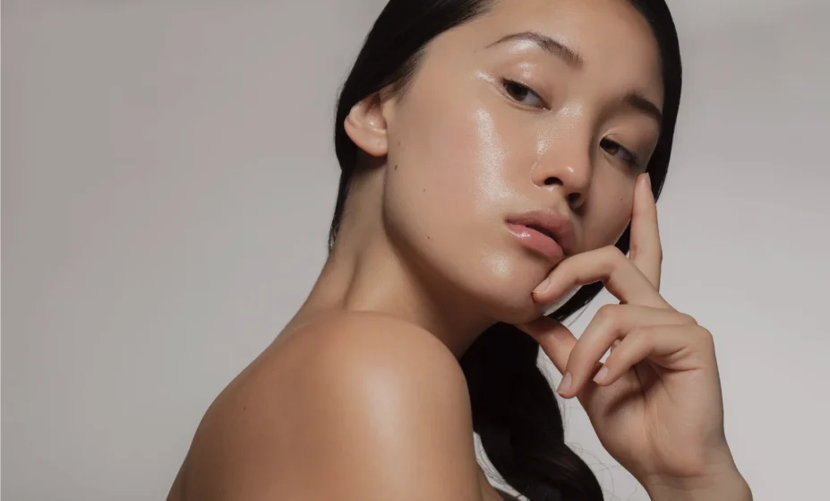 Model posing to show off a clear, glowing, and hydrated complexion achieving Glass Skin.