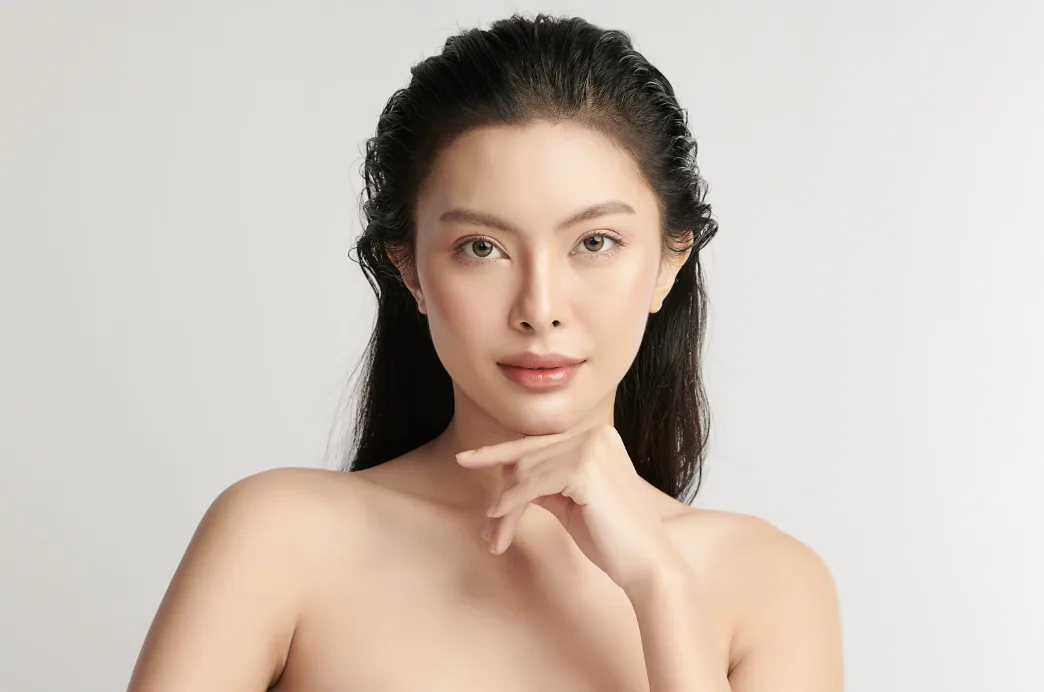 Portrait of a woman with firm, smooth facial contours posing after a Skin laxity Treatment singapore.